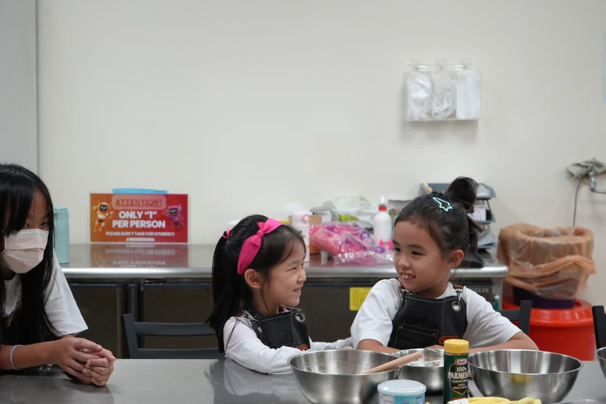TYAS elementary students smiling together during a cooking activity
